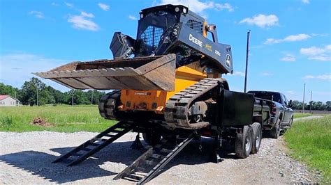 dump trailer hauling skid steer|skid steer trailer moving attachment.